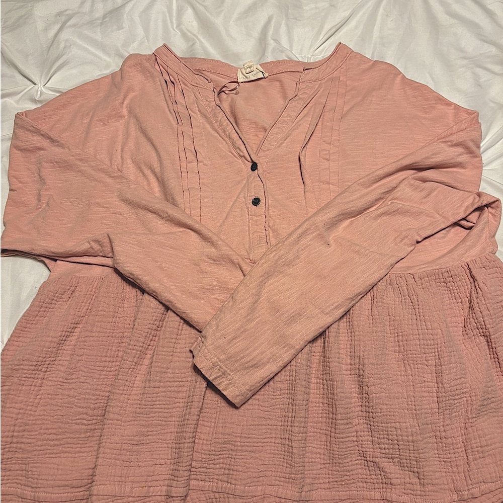 Cute top. Looks really cute with jeans. Has fringe on the bottom of shirt.
